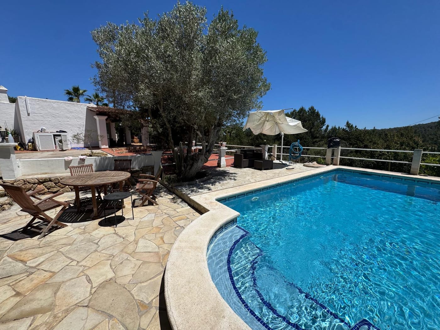 The pool, with the main villa in the background